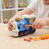 Child playing with Cogs & Conductor Construction Train Set, using a screwdriver on colorful train components.