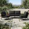 3-Piece Outdoor Patio Set featuring a stylish black cushion sofa and chairs on a stone patio surrounded by greenery.