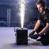 A technician operating a Cold Spark Machine, creating spark effects on stage during an event.