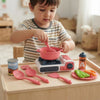 Kids Kitchen Pretend Playset with Cooking Accessories - child playing with toy stove and colorful cookware.