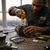 A mechanic using the 2 Piece Stubby Precision Screwdriver Duo on machinery in a workshop.