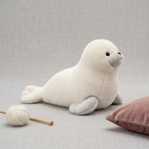 Plush Seal Soft Toy sitting on a gray surface, featuring soft textures and playful design, ideal for kids and collectors.