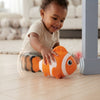 Child enjoying the Interactive Clownfish Crawling Toy as it moves playfully across the floor.