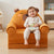 Childrens Animal Sofa Chair with a child happily reading a book while seated comfortably.
