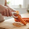 Person using a Multi-Functional Stainless Steel Vegetable Peeler on carrots in a kitchen.