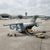 Military Transport Aircraft Toy Set with a large aircraft and miniature vehicles on a tarmac.