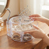 3-Tier Clear Swan Jewellery Organizer with rotating design and swan handle, displaying rings and bracelets on a wooden table.