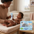 Mother applying Soothing Baby Care Nappy Rash Cream on a smiling baby in a cozy nursery.