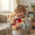 Child hugging Colorful Heart Bear Plush Toy in a cozy living room setting.