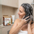 Woman using Tuber Fleeceflower Root Extract Shampoo Soap in the shower for healthy hair care.