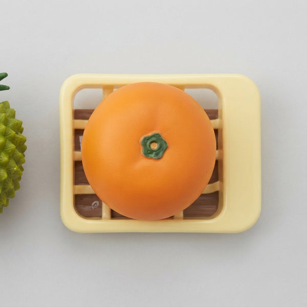 Playful Produce Cutting Set featuring an orange piece on a yellow cutting board with a green basket.