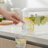 3.5L Beverage Dispenser with Tap and Lid pouring lemon mint drink into a glass.