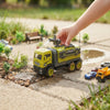 Child playing with the Alloy Tractor Head Watering Truck Play Set watering a miniature garden scene.