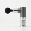 Portable Mini Massage Gun in gray and silver with a detachable massage attachment.