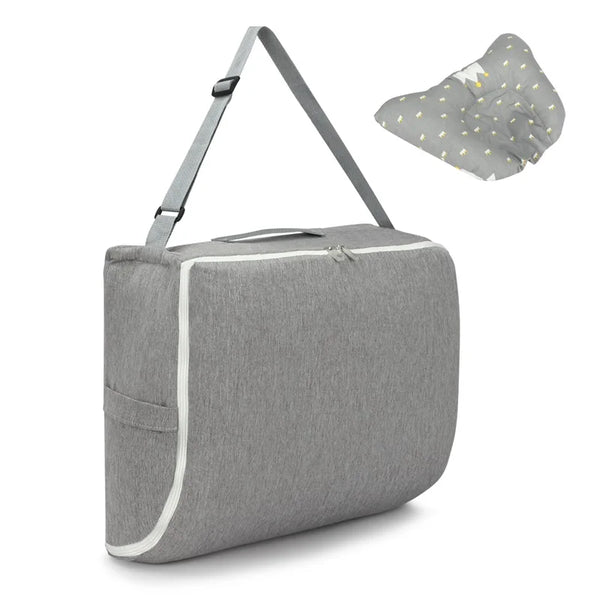Fashionable 2 in1 Baby Travel Bed showing a gray crossbody diaper bag turned into a travel bed with a pillow.