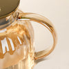Elegant Large Capacity All-Glass Tea Set with a clear glass handle and stylish lid for modern tea serving.