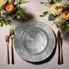 European Style 13-Inch Gold Rim Dinner Plate on a table set with gold utensils and floral arrangements.