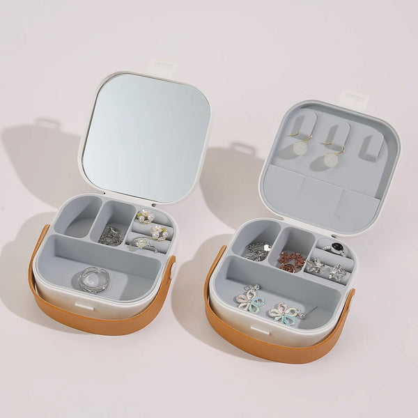 Compact Travel Jewelry Organizer with Integrated Mirror showing open compartments and a mirror for easy accessorizing.