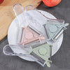 Multi-purpose Plastic PP Kitchen Vegetable Peeler in pink, green, and grey on a plate.