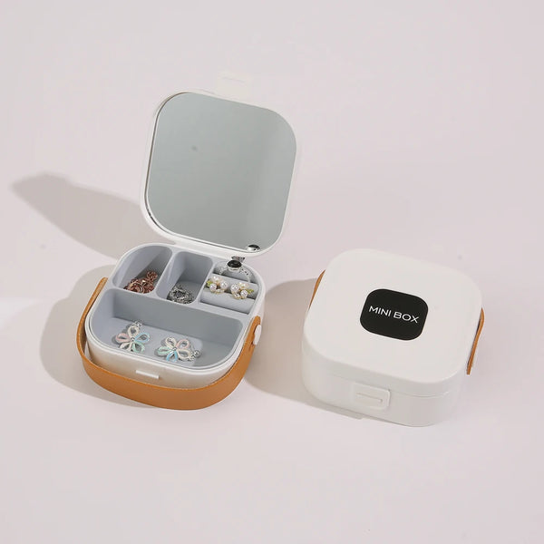 Compact Travel Jewelry Organizer with Integrated Mirror displaying compartments for jewelry.