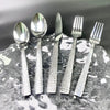 5-Piece Silverware Set displayed on a silver plate highlighting stainless steel flatware for a complete dining experience.