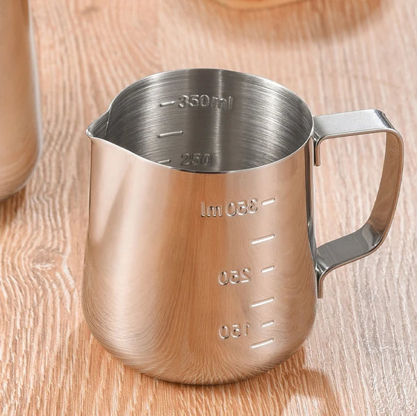 Silver Coffee Latte and Milk Frothing Pitcher 350ML with measurement markings on a wooden table.