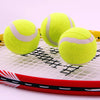 Three Anti-abrasion Practice Tennis Balls resting on a tennis racket, showcasing their bright yellow color and durability.