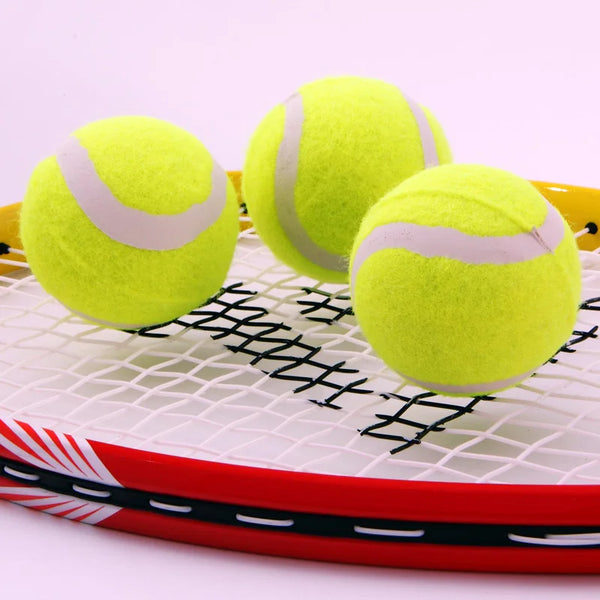 Three Anti-abrasion Practice Tennis Balls resting on a tennis racket, showcasing their bright yellow color and durability.