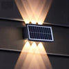 Solar LED RGB Wall Light installed on wall, showcasing its solar panel and vibrant lighting effects.