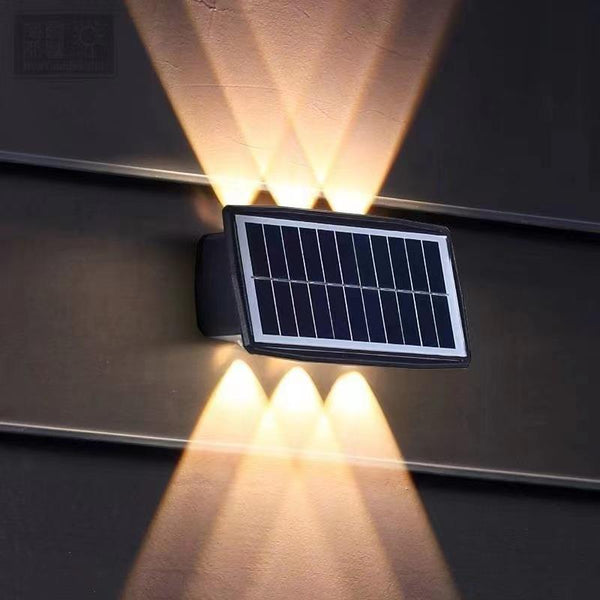 Solar LED RGB Wall Light installed on wall, showcasing its solar panel and vibrant lighting effects.