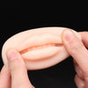 Silicone Lip Tattoo Practice Skin held in hands demonstrating its realistic texture and contour for permanent makeup training.