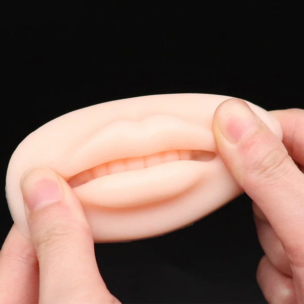 Silicone Lip Tattoo Practice Skin held in hands demonstrating its realistic texture and contour for permanent makeup training.