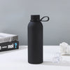500ml Matte Rubberized Insulated Sports Bottle on a table with ice cubes and books in the background.