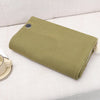 Wearable USB Heated Shawl for Winter folded on a sofa, perfect for staying warm indoors and outdoors.