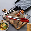 Heat Resistant Silicone Tipped Stainless Steel Tongs displayed with grilled chicken and roasted potatoes