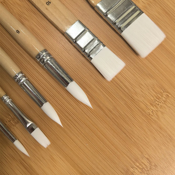 6-Piece Nylon Paint Brush Set with Wooden Handles displayed on a wooden surface, showing various brush sizes and shapes.