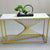 Nordic Golden Marble Console Table with geometric golden base and decorative items on a white marble top.