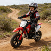 Child riding the 24V Electric Dirt Bike on a dirt trail in a helmet and protective gear.