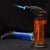 FD999 Modern Transparent Body Plastic Welding Gun igniting with flame, showing high-clarity gas level reservoir.