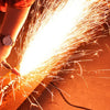Person using a grinding tool, creating sparks during metal working with 10Pcs Ceramic Abrasive Stone Mounted Grinding Set.