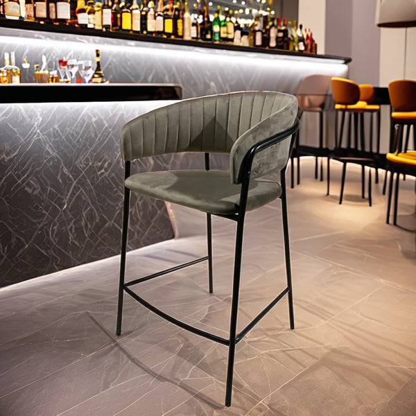 Upholstered Bar Stool with Curved Back and Black Metal Frame in a modern bar setting.