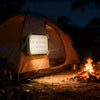 Strong Mobile Portable Camping Solar Light illuminating a camping scene at night by the fire.