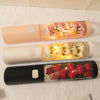 Cylinder Floral Display Box with Soap Roses in cream, pink, and black packaging with lights.