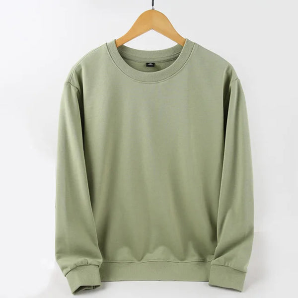 Unisex Oversized Blank Hoodies in soft green color hanging on a wooden hanger, showcasing its relaxed fit.