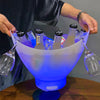 7L Bluetooth LED Ice Bucket with Speaker and Light Effects holding bottles and glasses, illuminated in blue light.