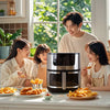 Family enjoying meals prepared with the 15-Liter Large-Capacity PBT Air Fryer on a sunny kitchen table.