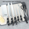 Stainless Steel 8 Piece Kitchen Knife Set displayed on a cutting board with lemon slices.