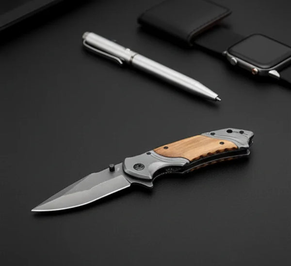 3D Pattern Blade Olive Wood Handle Pocket Knife placed on a black surface with a pen and watch.