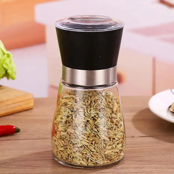 Manual Stainless Steel Pepper & Salt Grinder Mill filled with spices, ideal for enhancing meal flavors.
