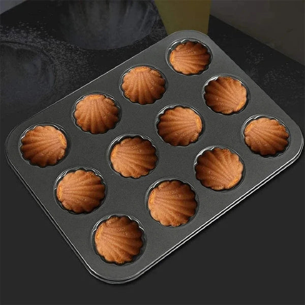Carbon Steel Shell Shape Baking Mold with twelve fluted baked madeleines in a tray.
